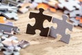 Black and Grey Jigsaw Puzzle Pieces on Table Royalty Free Stock Photo