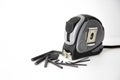 Black and grey measuring tape with a family of L-shaped hexagon wrench with front View 45ÃÂ°, selective focus and abstractly arrang Royalty Free Stock Photo