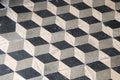 Black and grey mosaic tiles laid out in a geometric cube pattern Royalty Free Stock Photo