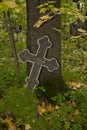 Black with grey rim mosaic Orthodox cross on an old autumn cemetery. Royalty Free Stock Photo