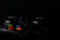 Black & Grey Video Games Controller in Dark Dramatic Lighting With Colored Buttons