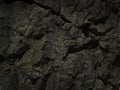 Black grunge background. Rough stone surface with cracks. Black rock texture.