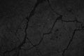 Black grunge background. Texture of cracked concrete wall. Close-up. Royalty Free Stock Photo