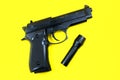 Black gun and flashlight lies on a yellow background. Private detectives work. Searching information concept