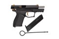 Black gun with gilded elements isolate on a white background. Gift weapon on a light back