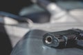 Black gun inside the car. For violence on the road concept Royalty Free Stock Photo