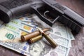 Black gun and weapon bullets on USA dollars background. Military industry, war, global arms trade and crime concept Royalty Free Stock Photo