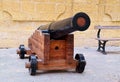 Black ancient cannon on a wooden gun carriage, Malta