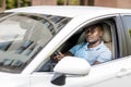 Black guy driver in casual driving white automobile Royalty Free Stock Photo