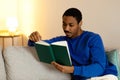 Black Guy Enjoying Good Read Sitting With Book At Home