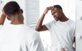 Black Guy Examining His Head Searching Gray Hair In Bathroom Royalty Free Stock Photo
