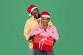 Black guy giving Christmas gift to his girlfriend, wife Royalty Free Stock Photo