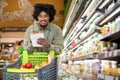 Black Guy Holding Shopping List Taking Notes In Supermarket Royalty Free Stock Photo