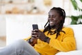 Black Guy Messaging With Friends Or Browsing Internet On Smartphone At Home Royalty Free Stock Photo