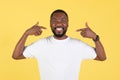 Black Guy Pointing At Himself Smiling To Camera, Yellow Background Royalty Free Stock Photo