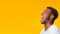 Black Guy Screaming Loudly Standing In Studio, Panorama, Side View Royalty Free Stock Photo
