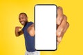 Black Guy Showing Cellphone With Huge Empty Screen, Yellow Background