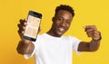 Black Guy Showing Phone With Mobile Navigation App, Yellow Background