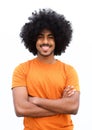 Black guy smiling with arms crossed against white background Royalty Free Stock Photo