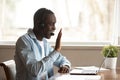 African guy wearing headset starting lesson online greeting tutor