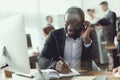 A black guy works as a call center operator. Royalty Free Stock Photo