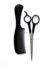 black hair comb and scissors for cutting hair on a white isolated background Royalty Free Stock Photo