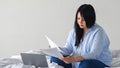 Black-haired lady receives positive letter from company