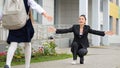 Black-haired mother meets girl child from primary school