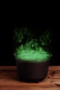 Black halloween cauldron with green smoke Royalty Free Stock Photo