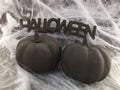 Black Halloween word with Black pumpkins and spider web Royalty Free Stock Photo