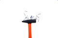 Black hammer with orange handle on a white background. Nearby are gray metal nails. Isolated. Copyspace Royalty Free Stock Photo