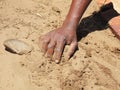 Black hand on sandy soil Royalty Free Stock Photo