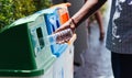 Black hand throwing an empty plastic water bottle in the recycling garbage trash Royalty Free Stock Photo