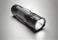 black handheld flashlight on a white background.