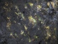 Black handmade background of acrylic paints with a golden patina