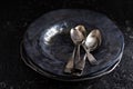 Black handmade ceramic plates with vintage spoons
