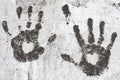 Black handprints on an old white wall. Silhouettes of the heart on the palms Royalty Free Stock Photo