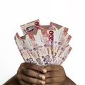 Black hands holding 3D rendered 200 Ghanaian cedi notes. closeup of Hands holding Ghanaian currency notes Royalty Free Stock Photo