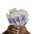 Black hands holding 3D rendered 10000 west African Cfa franc notes. closeup of Hands holding Cfa franc currency notes Royalty Free Stock Photo