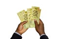 Black Hands in suit holding 10000 Burundian franc notes Royalty Free Stock Photo