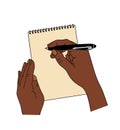 Black Hands writing with pen in spiral notepad. Royalty Free Stock Photo