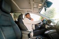 Black handsome business man driving the car talking on smartphone.