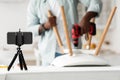 Black handyman blogger shooting video instructions for assembling furniture at home with own hands, selective focus Royalty Free Stock Photo