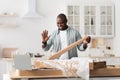 Black handyman shooting video instructions for assembling furniture at home with own hands, waving to laptop at home Royalty Free Stock Photo