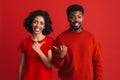 Black happy man and woman smiling and gesturing at each other