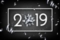 Black 2019 happy New Year card with silver bow and serpentine.