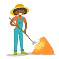 A black happy woman with a pitchfork and a haystack.