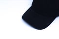 A Black Hat in The Corner White Background with Oblique Top Shot, Landscape Mode