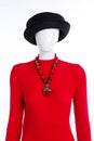 Black hat, red sweater and necklace.