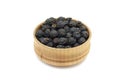 Black hawthorn berries in a wooden bowl